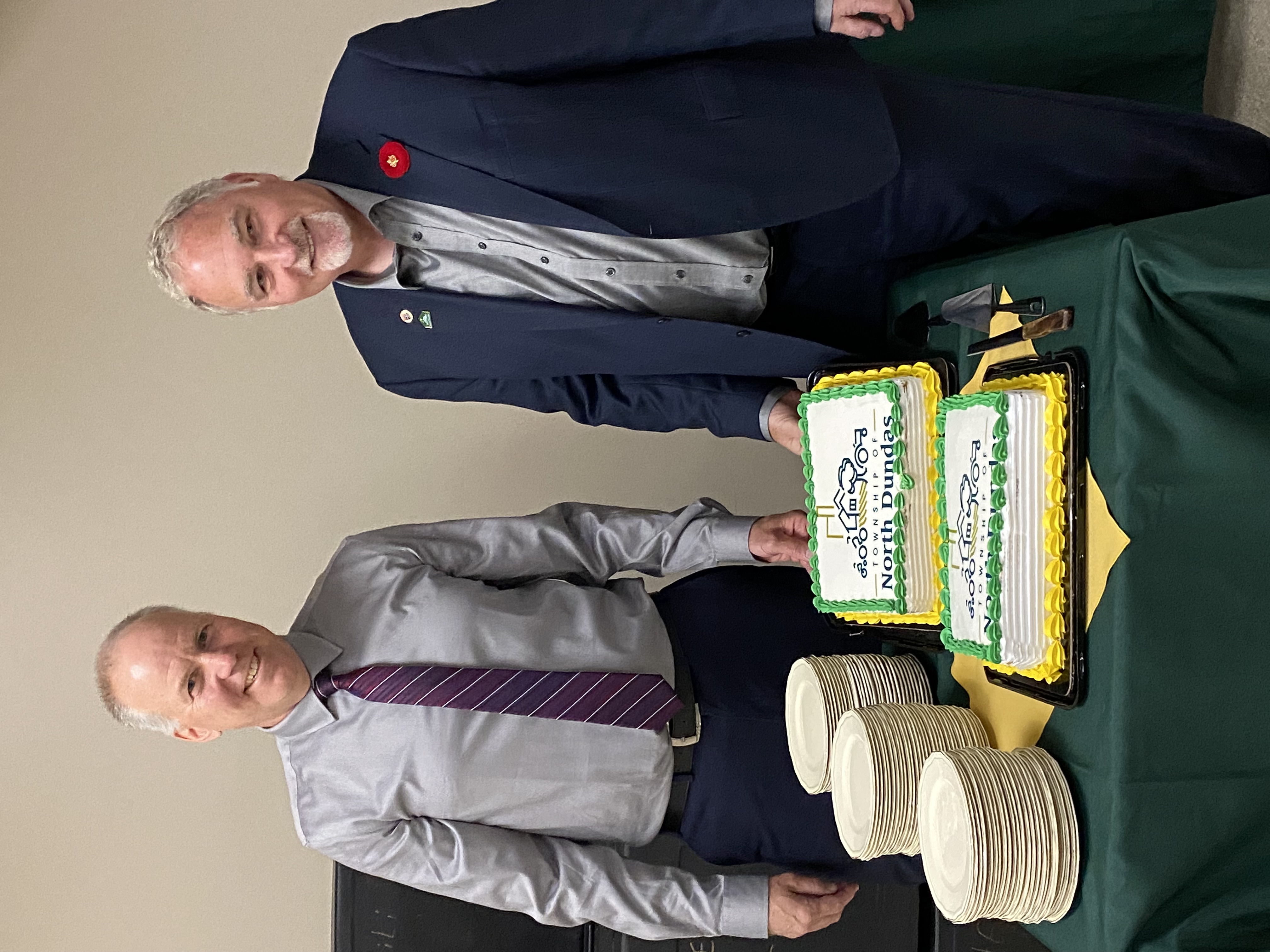 Al and John with cake photo at retirement celebrations