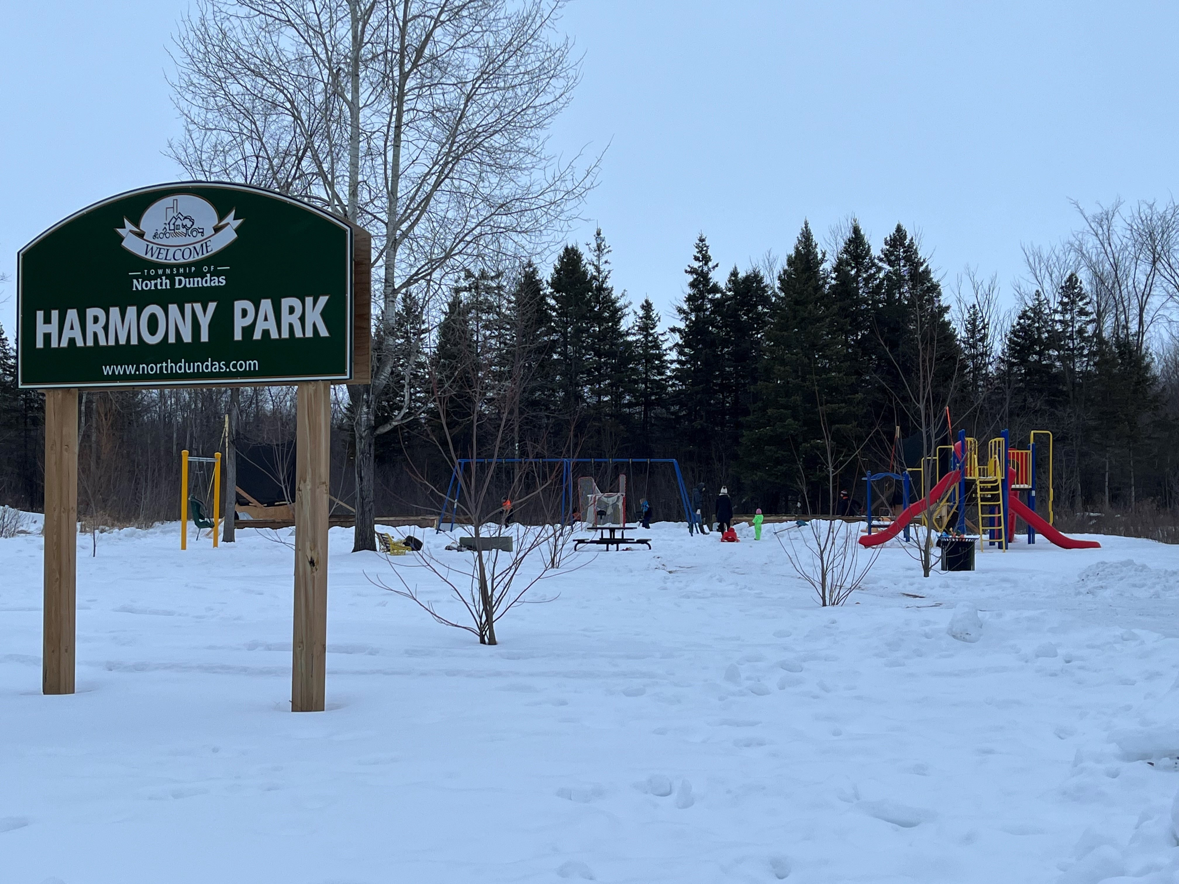 Park sign with rink in the background
