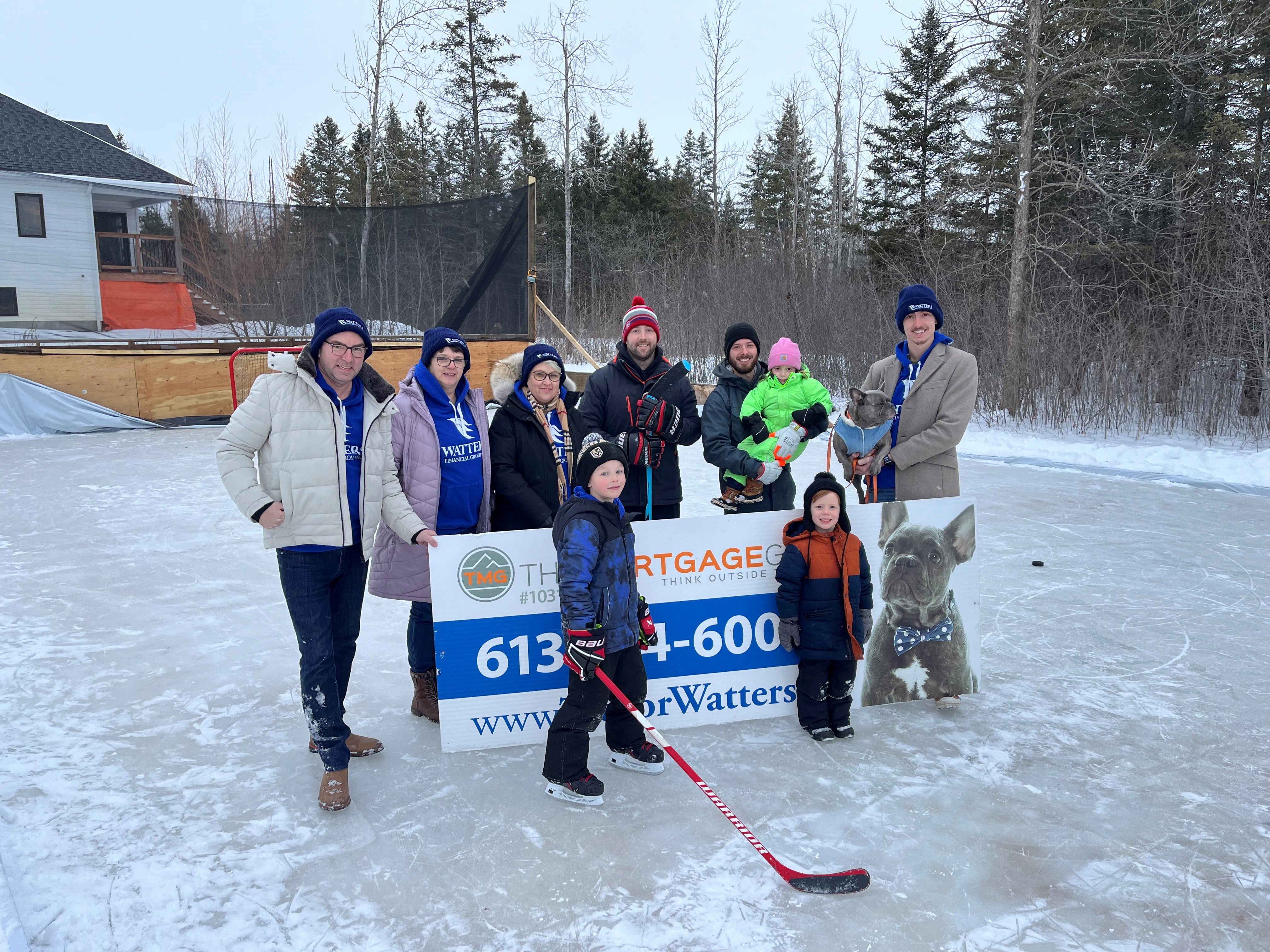 People standing in a group picture on the ice