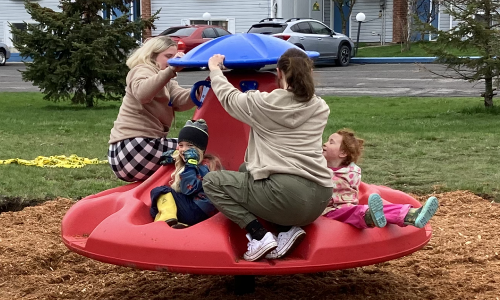 People spinning on a Ten Spin playground equipment toy