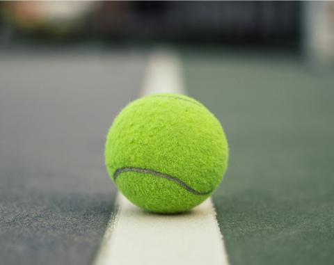Yellow tennis ball on court