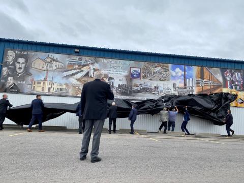 Stephen Ault watches the unveiling of a new mural to commemorate the Ault family legacy.