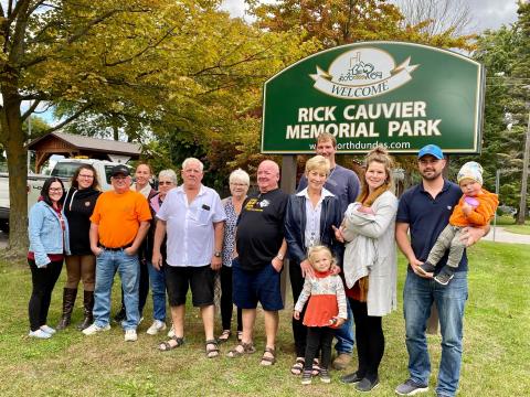 Sherry Mowat stands with members of her family under the new Rick Cauvier Memorial Park sign in South Mountain. 