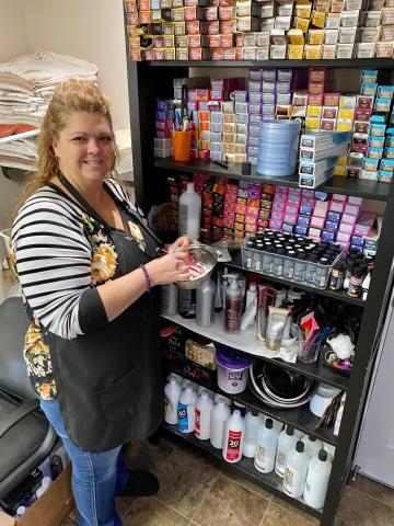 Karen Parker mixes up some dye for her next client. 