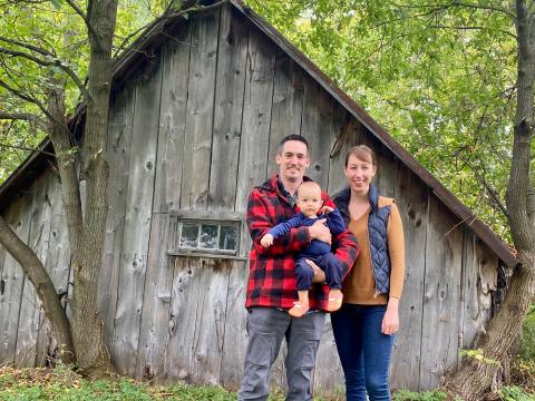 Chris Power stands with his wife Elise and their son Victor. 