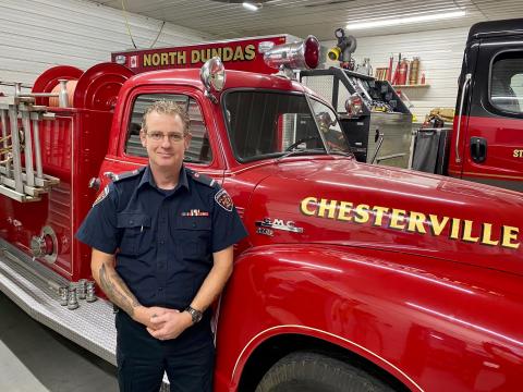 Sean Donovan stands in front of a North Dundas fire truck. 
