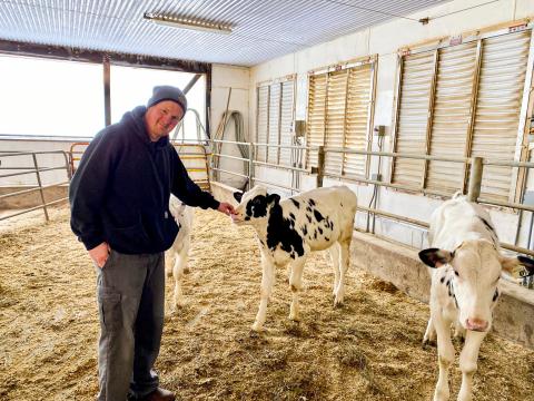 Doug MacGregor hanging out with some baby cows at his family farm in Morewood.
