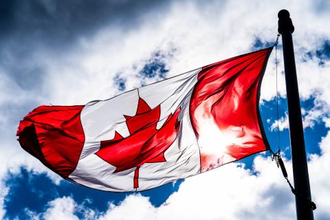 canada flag on blue sky