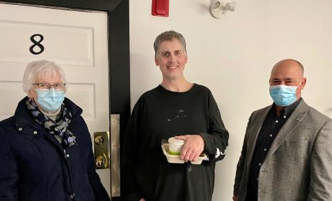 1)	Pictured, Meals on Wheels volunteer Gerry (left) delivers a meal to Jeff (center) on Wednesday, March 23, accompanied by North Dundas Mayor Tony Fraser (right). 