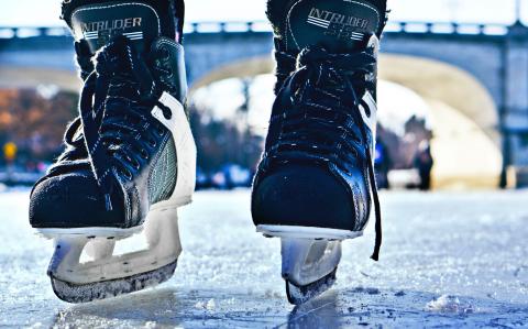 black hockey skates on ice