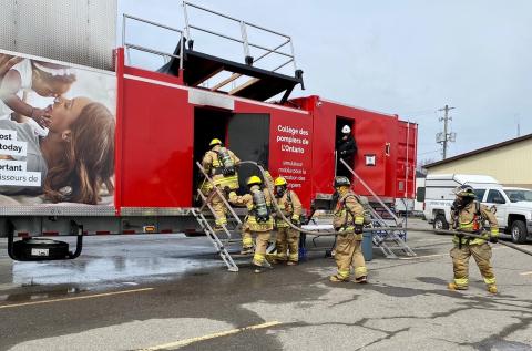 Red fire training trailer showing firefighters entering 