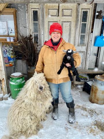 Ruth Vanderlaan, pictured with Stan the Komondor and a baby goat – the product of a broken door. 