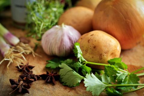 raw garlic and herbs on cutting board