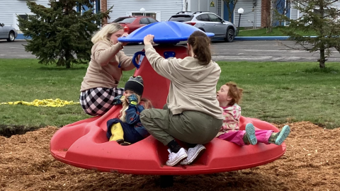 People spinning on a Ten Spin playground equipment toy