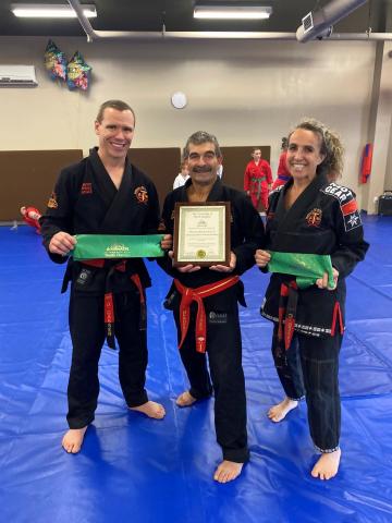 Therien Martial Arts instructors holding scroll and ribbon