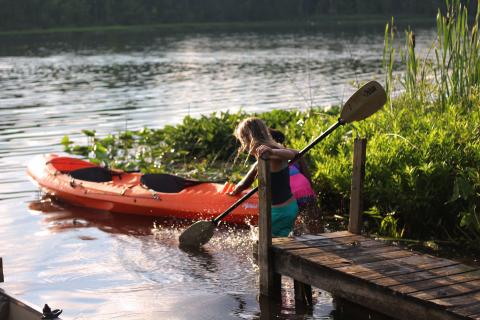 kids with red kayak in water