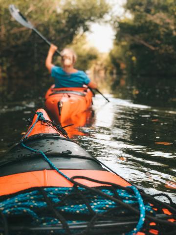 Orange kayak on open waters