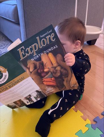 Child holding Explore North Dundas publication