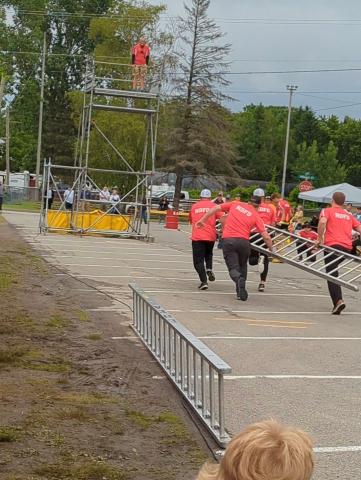 fire fighters running with ladder