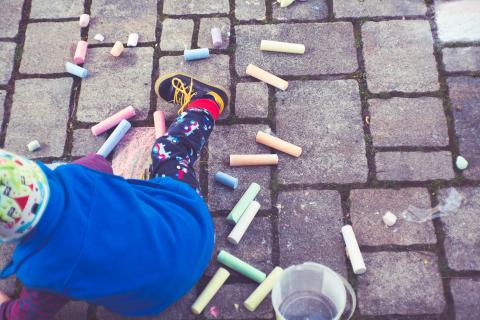 Kid doing sidewalk chalk