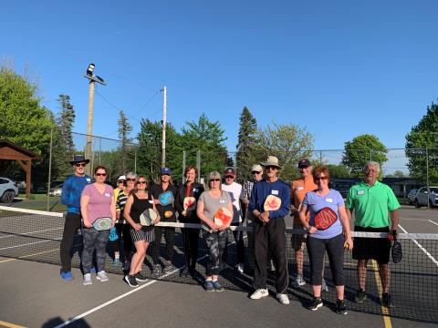 Pickleball Players standing by net