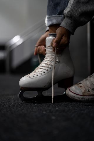 someone tying up a figure skate